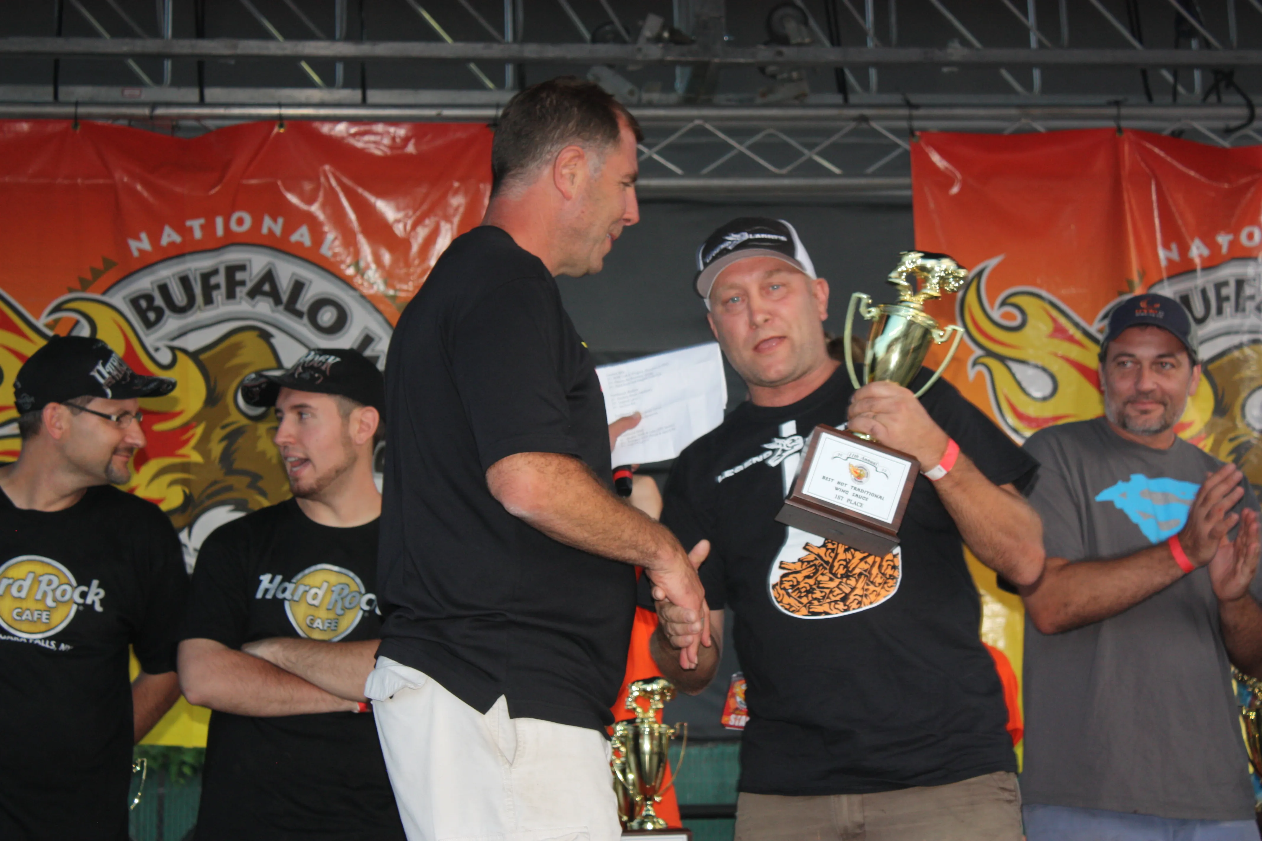 Larry receives an award from Drew Cerza at the Wing Festival, 2012